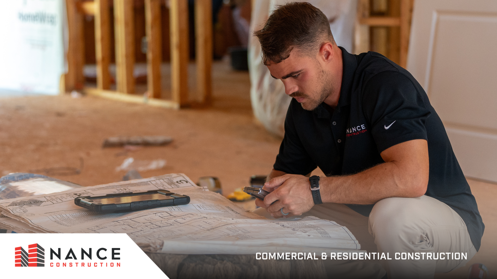 Commercial project consultation with contractor reviewing plans on a tablet